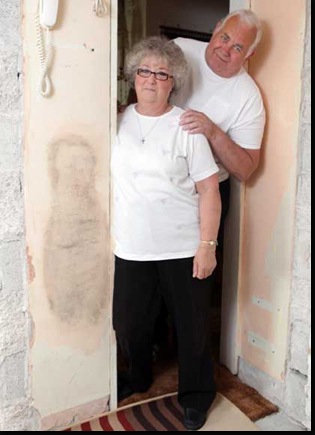 Richard and Shiela Woolhouse at home in St Austell, Cornwall where a mysterious damp patch has appeared on wall whilst they were carrying out diy work to their kitchen .  9 June 2010. The damp marking 