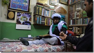 This-photograph-taken-on-March-2-2014-shows-Pakistani-pir-Syed-Izhar-Bokhari-L-with-a-devotee-AFP