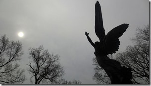 silhouette-of-a-gravestone-with-the-sun-in-clouds-royalty-free-image-1632864553