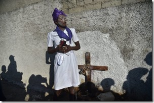 A woman voodoo devotee during a trance in the role of a spirit known as a Gede is seen in the ceremonies honoring the Haitian voodoo spirit of Baron Samdi and Gede spirits on the Day of the Dead in the Cemetery of Cite Soleil, in the Haitian Capital Port-au-Prince on November 2, 2018. - Voodoo believers and devotees offer candles, alcohol and food. The Day of the Dead is celebrated on the first two days of November during All Saints and All Souls Day. (Photo by HECTOR RETAMAL / AFP)        (Photo credit should read HECTOR RETAMAL/AFP via Getty Images)